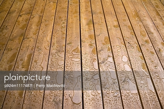 Wooden patio deck surface with water repellant stain applied