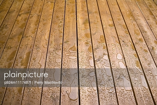 Wooden patio deck surface with water repellant stain applied