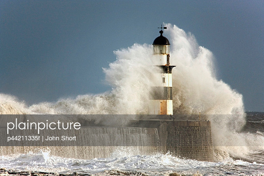 Waves Crashing Into A Lighthouse