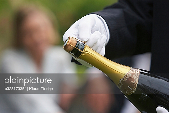 Waiter holding champagne bottle