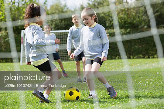 Children (6-7) playing soccer