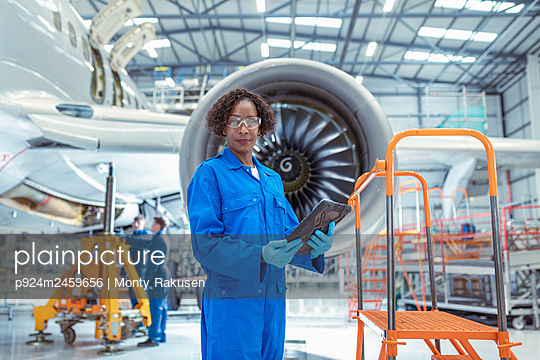 Portrait of female aircraft maintenance engineer in aircraft†hangar - p924m2459656 by Monty Rakusen