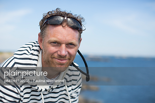 Portrait Of The Mature Man In Hooded Top    - p847m1102238 by Paulina Westerlind 