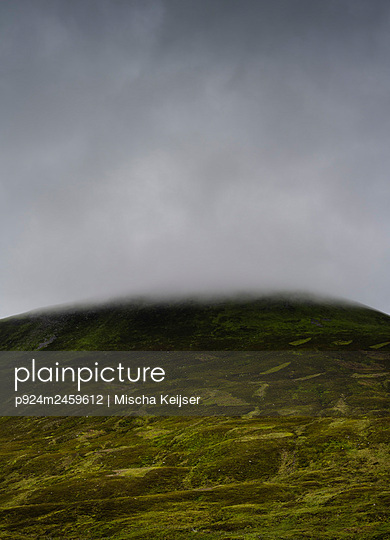 UK, Scotland, Storm clouds covering green hill - p924m2459612 by Mischa Keijser