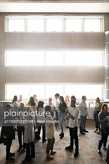 Business people talking, networking during conference coffee break - p1192m2123198 by Hero Images