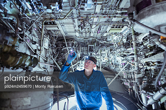 Apprentice aircraft maintenance engineer inspecting wheel well on jet - p924m2459670 by Monty Rakusen